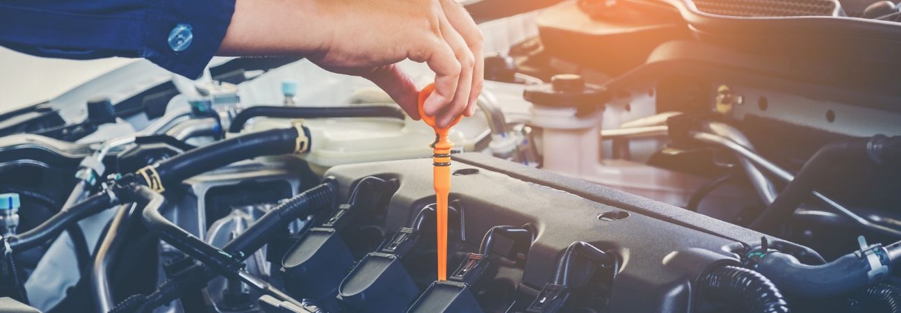 someone checking the oil in a porsche